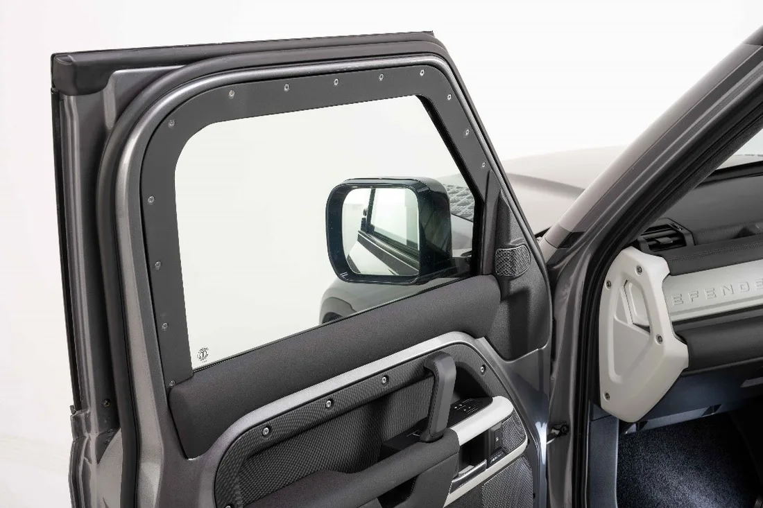 Certified ballistic glass with bolted frame in an open Defender door